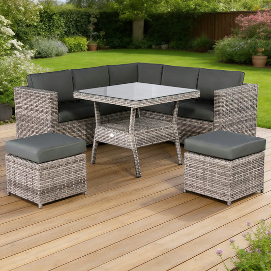 Lille grey rattan corner sofa and glass-top dining table set on patio
